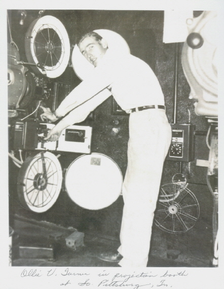 Ollie Vernon (Mutt) Turner preparing the projectors